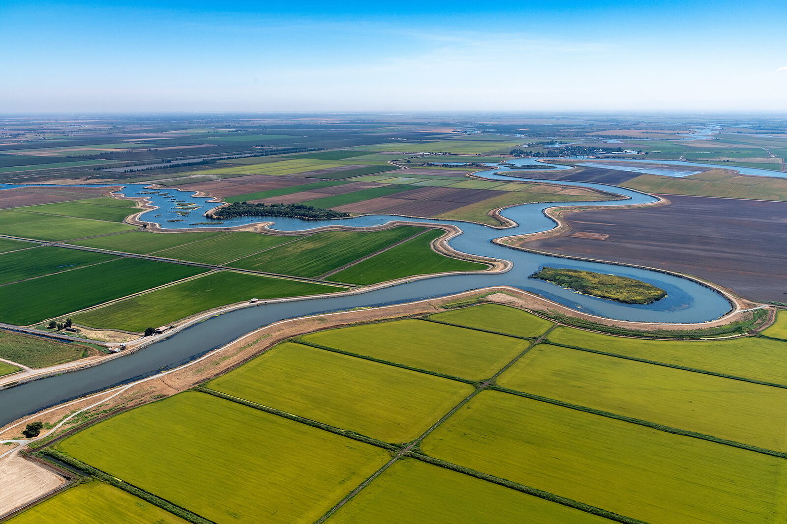 Aerial view of a river winding through farmland in the Sacramento–San Joaquin Delta